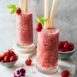 strawberry boba tea in two glass with straws on the table.