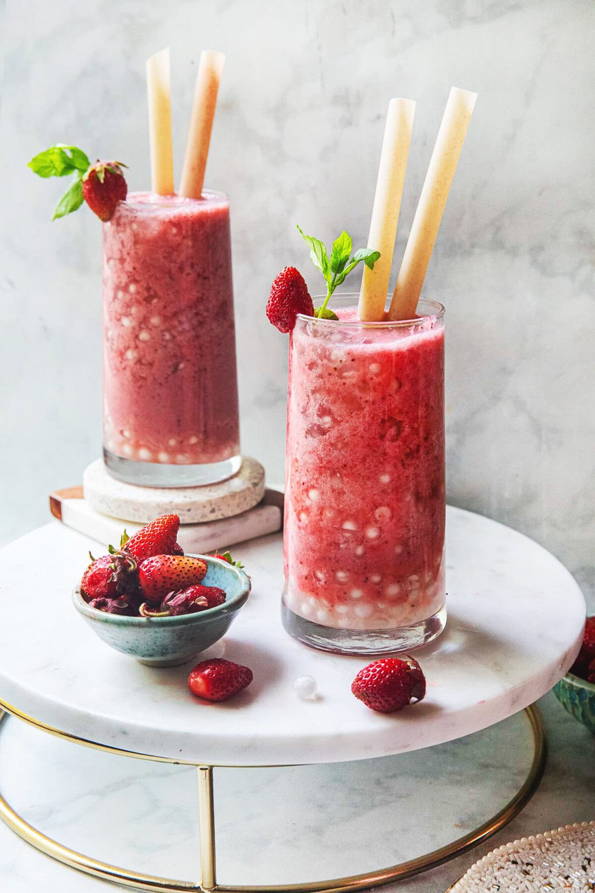 Fresh strawberry bubble tea in two glasses on a table. 
