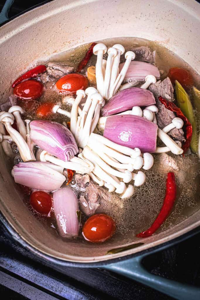 Tom Saap with pork ribs and vegetables in a pot on the stove.