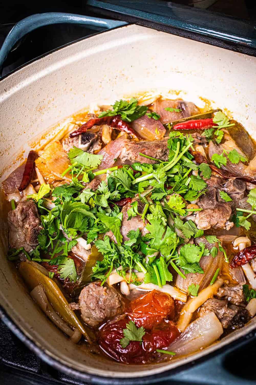 Tom Saap with pork ribs and vegetables in a pot on the stove.