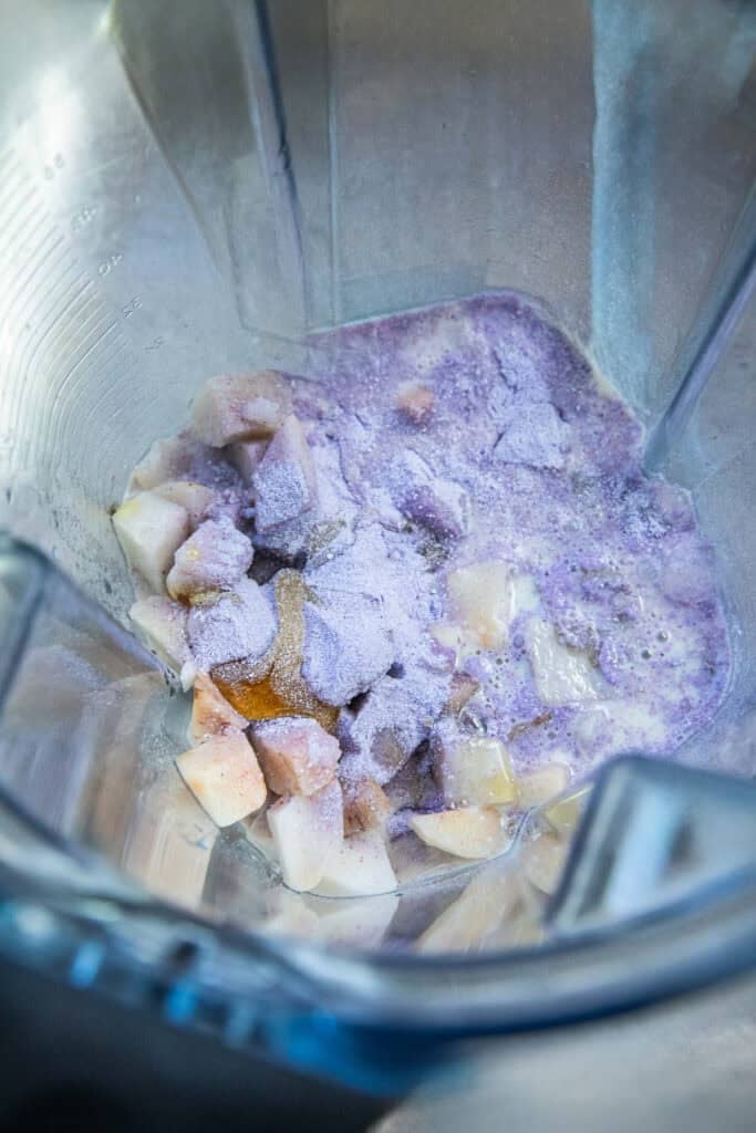 Fresh taro chunks and purple taro powder in a food processor. 