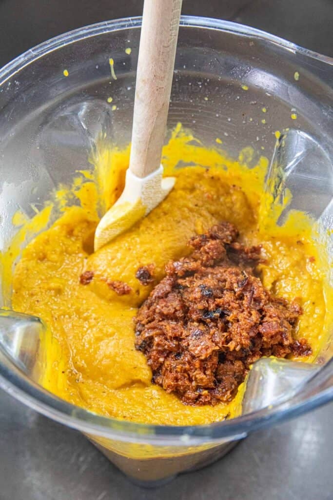 Thai red curry paste over a puree of Thai pumpkin curry in a blender.