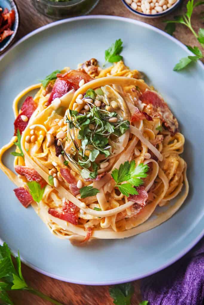 Creamy butternut squash fettucine pasta on a plate on the table. 