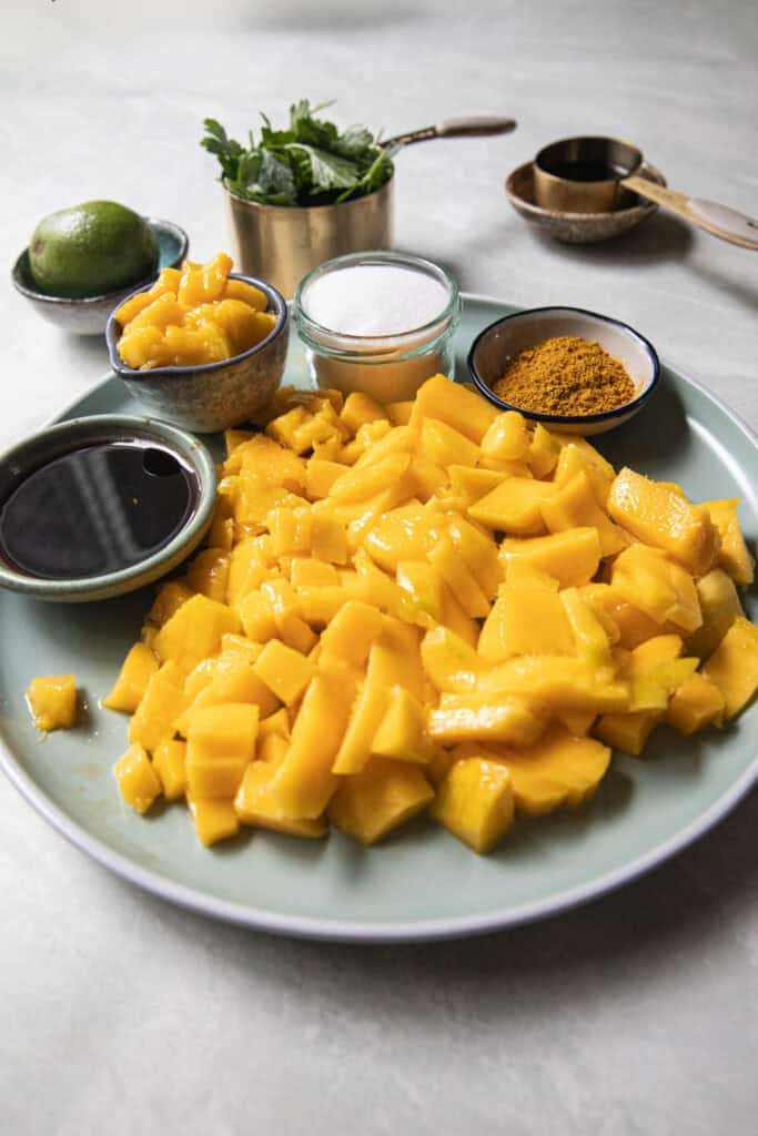 Ingredients for mango dipping sauce on a plate on the table. 