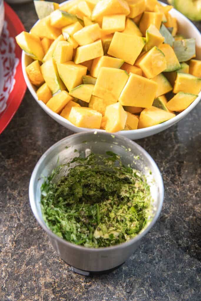 Green paste in a small grinder on the table. 