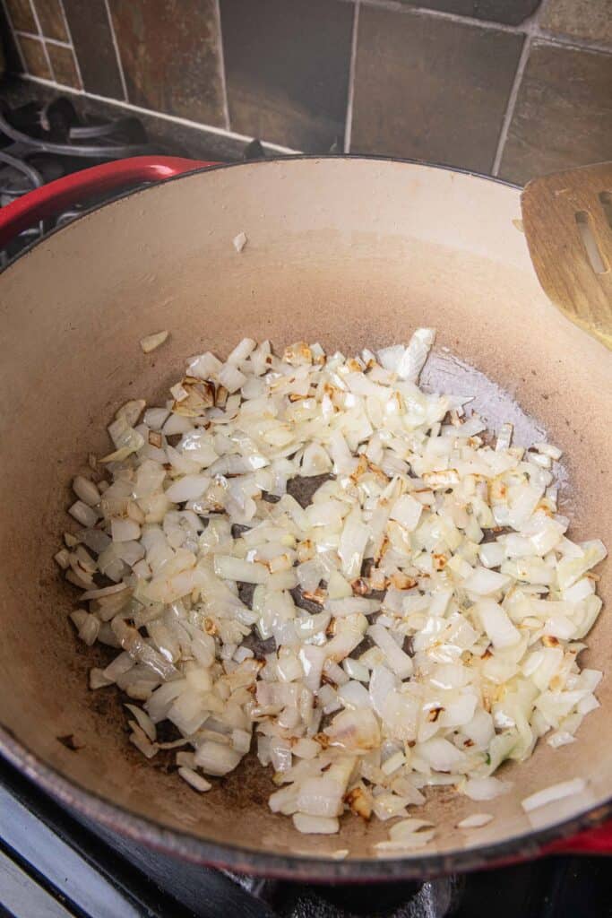 Sauteed onion and garlic in a pot on the stove. 