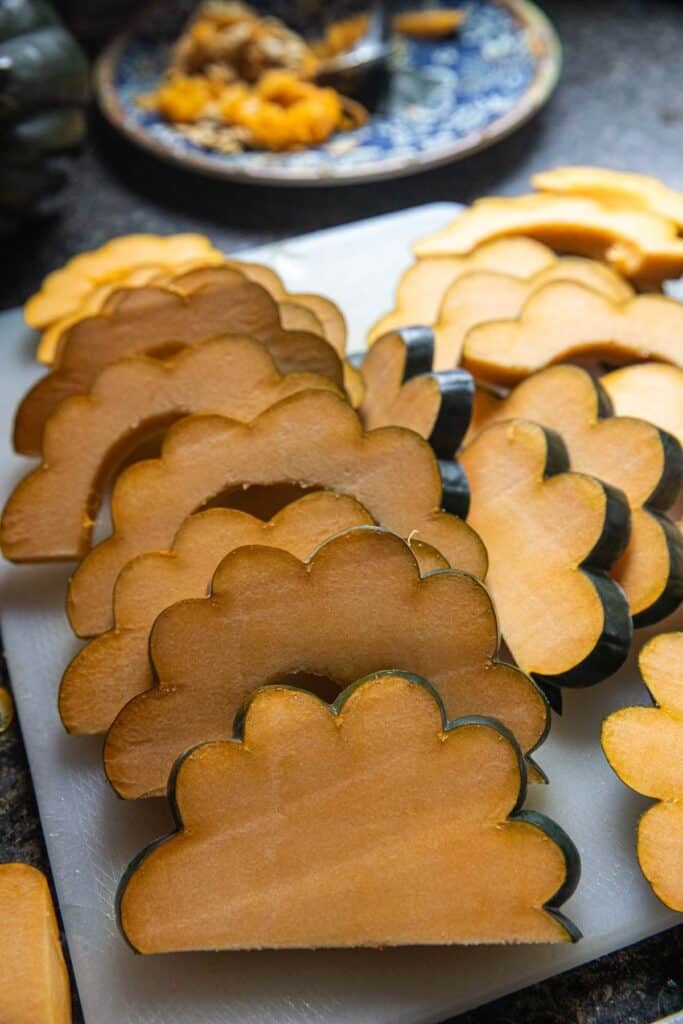Sliced acorn squash on a cutting board. 