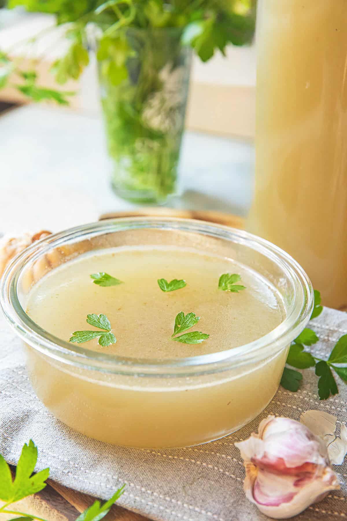 Thai pork stock in a bowl on a tablecloth with cilantro leaves garnish  on top.