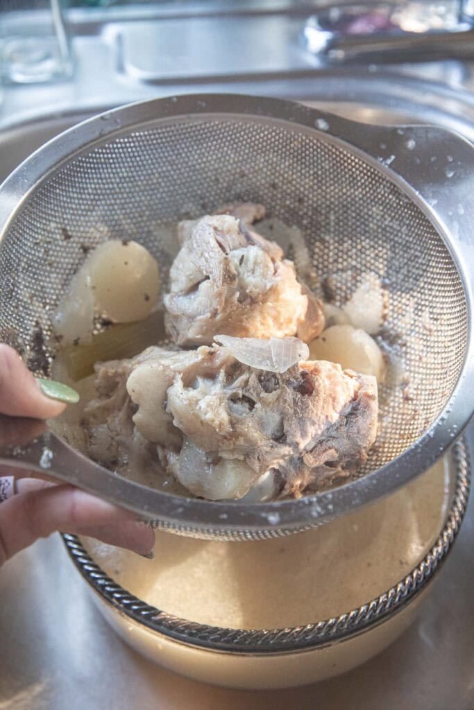 Boil pork broth, meat, and veggie chunks in a fine mesh strainer over a bowl of stock. 