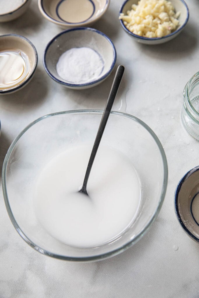 cornstarch slurry in a glass bowl on the table. 
