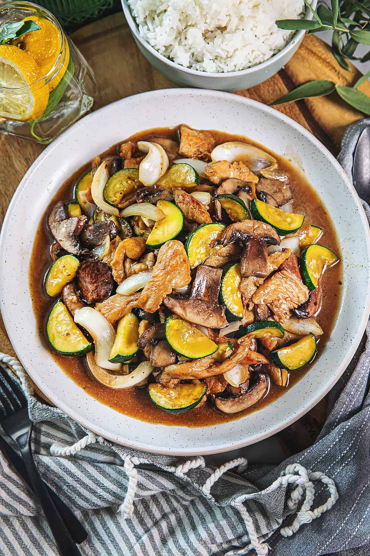 Chicken mushroom stir fry in a plate on a cutting board. 