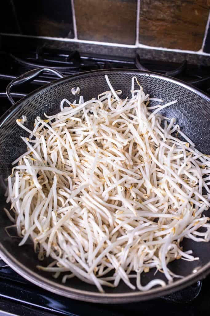 a large pile Bean sprout inside a wok. 