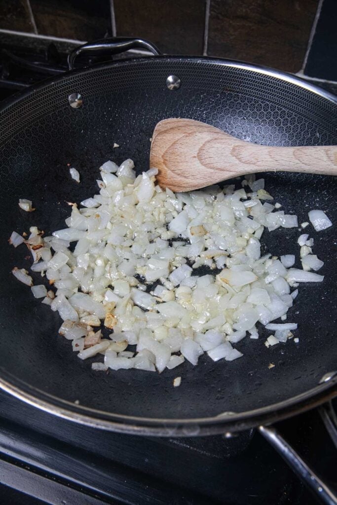 Sautéed onion and garlic in a wok.