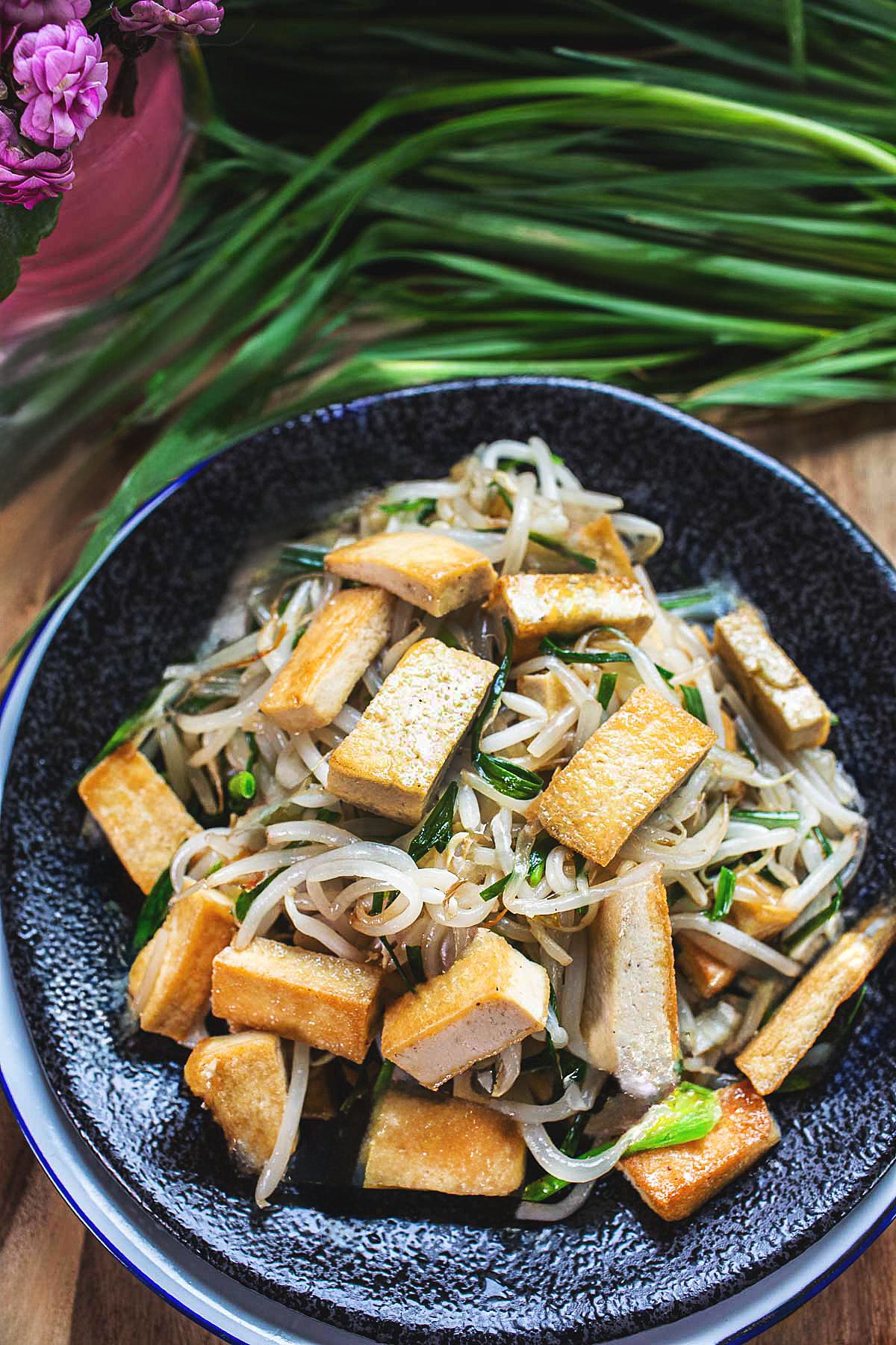 stir fry bean sprouts with chives in a plate on the table. 