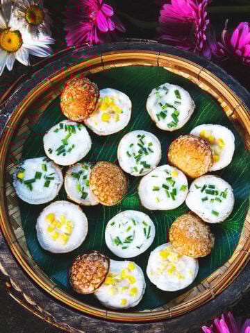Round kanom krok coconut pancakes on a basket.