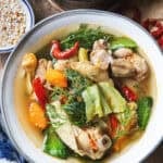 Gaeng Om Gai Isaan chicken soup with herbs, vegetables, and clear broth served with dill and Thai basil.