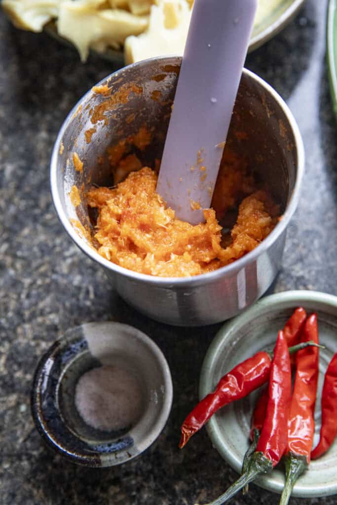 Chili paste for Gaeng Nor Mai in a spice grinder.