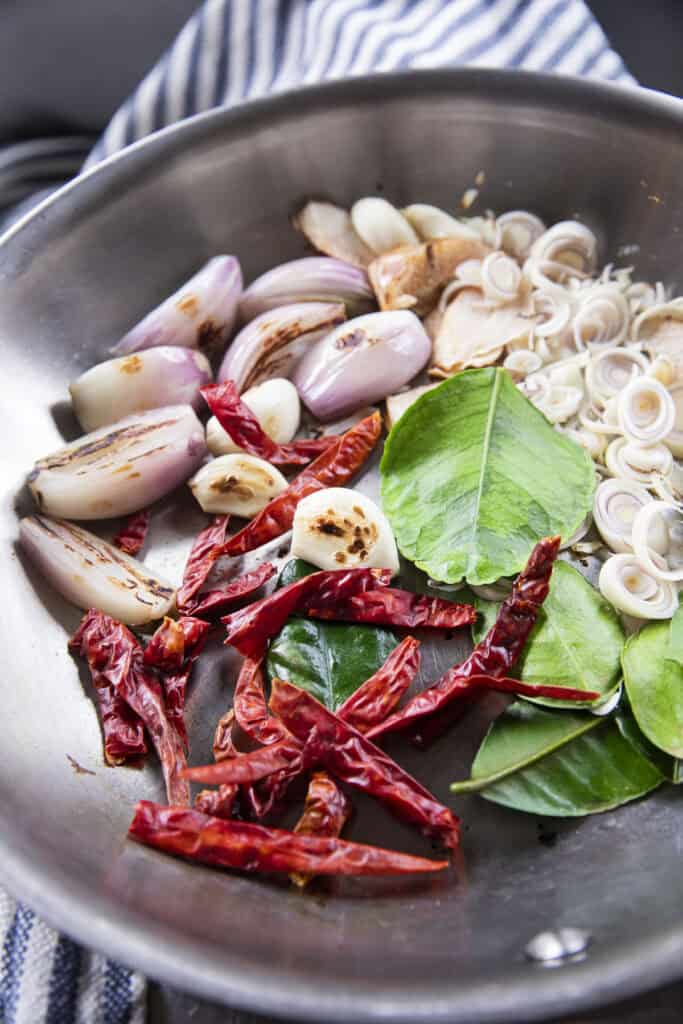 Kaffir lime leaves added last while toasting aromatics for Jeow Bong.