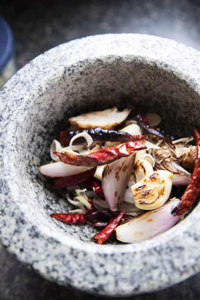 Blended Jeow Bong chili paste in a stone mortar before adding pork skin.