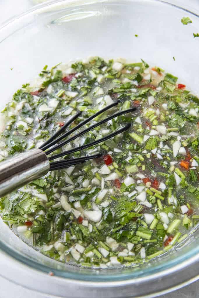 Leng Saeb dressing with broth in a bowl.