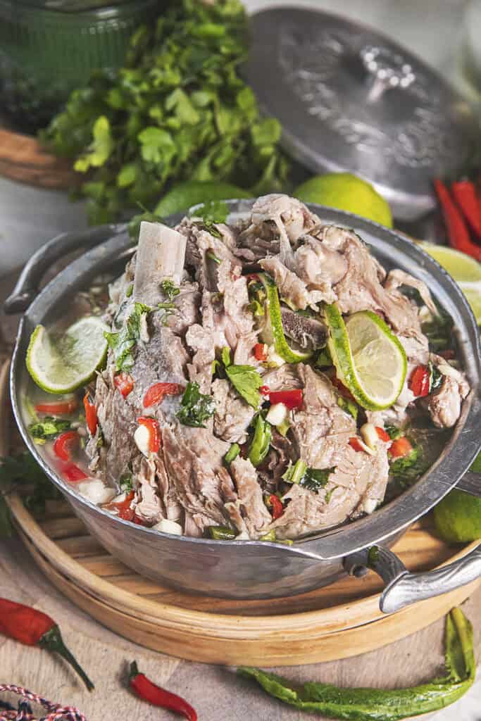 Leng Saap spicy pork bone soup in a large bowl on a table.