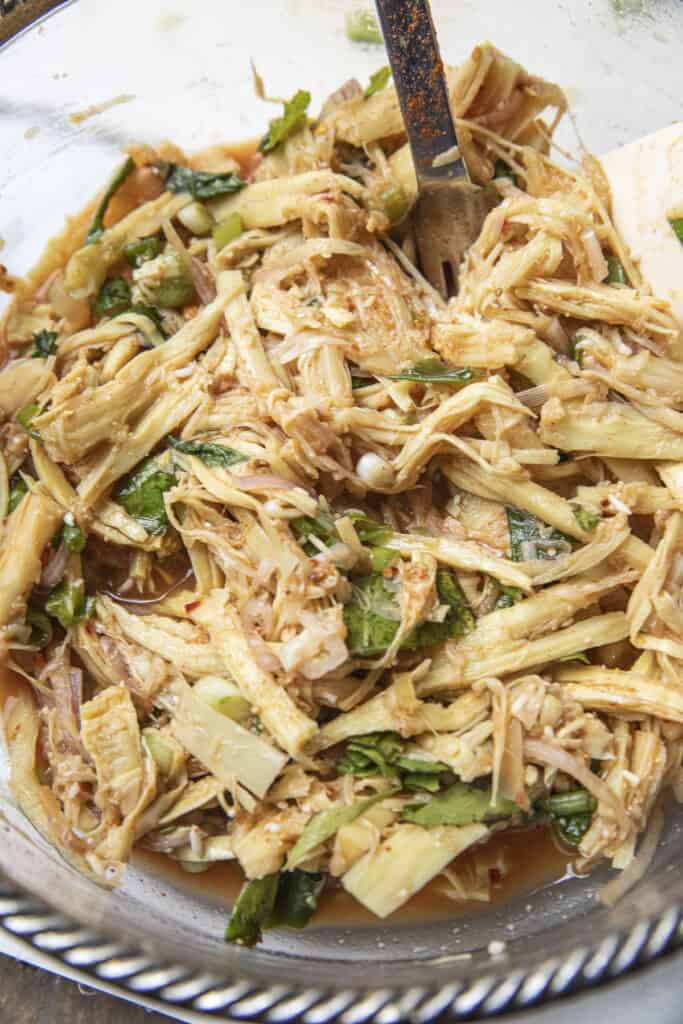 Thai bamboo shoot salad showing fibrous shredded bamboo texture.