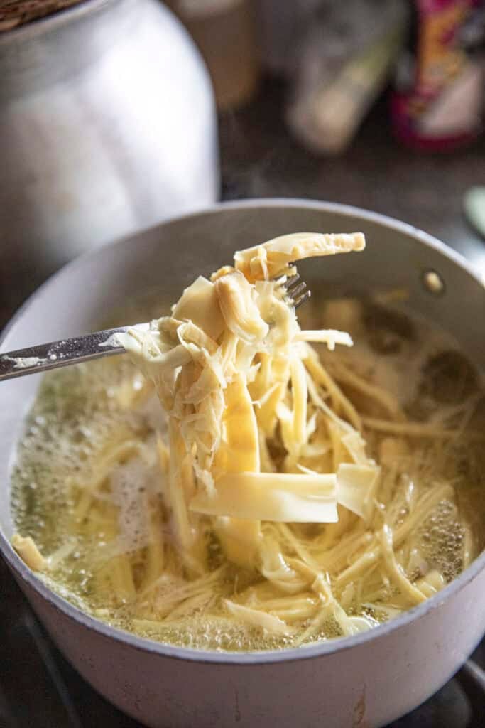 Shredded boiled bamboo shoots prepared for Thai bamboo shoot salad.