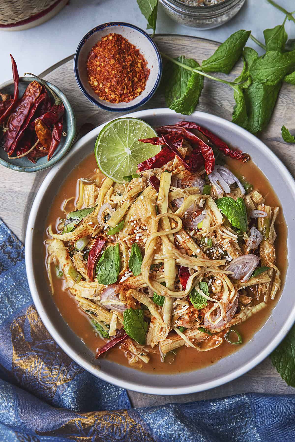 Soop Nor Mai Thai bamboo shoot salad served with herbs and toasted rice.
