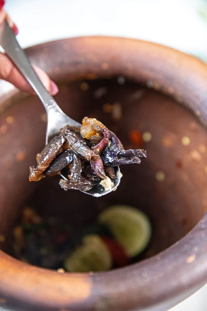 Fermented crab added to papaya salad.
* Isaan som tum pu pla ra mixed in clay mortar