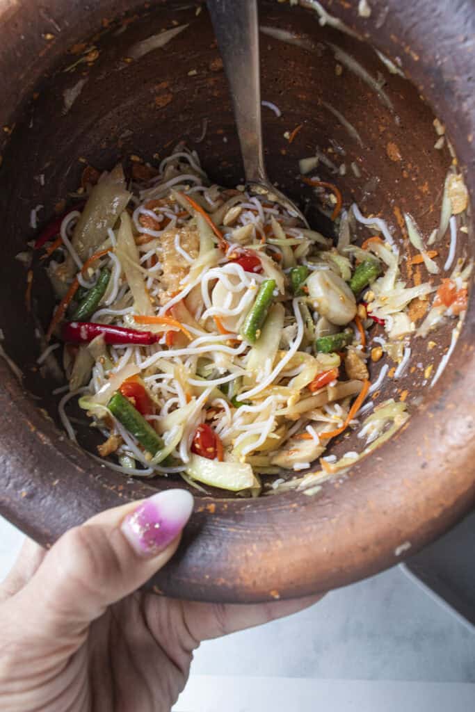 Som Tum Mua loaded Thai papaya salad with noodles, long beans, tomatoes, and dried shrimp.