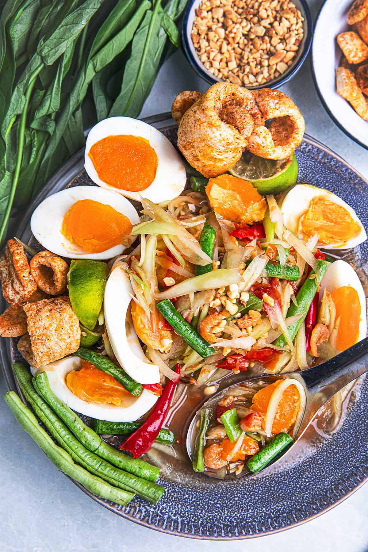 som tum kai kem plated with thai vegetables.