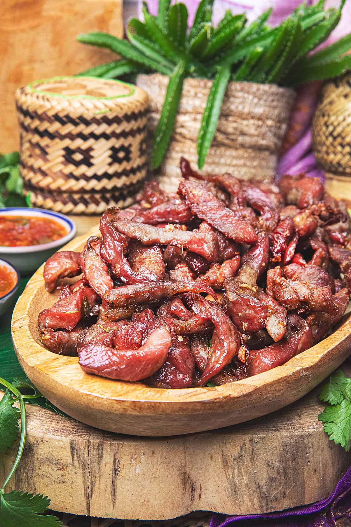 thai pork jerky on a platte served with sticky rice
