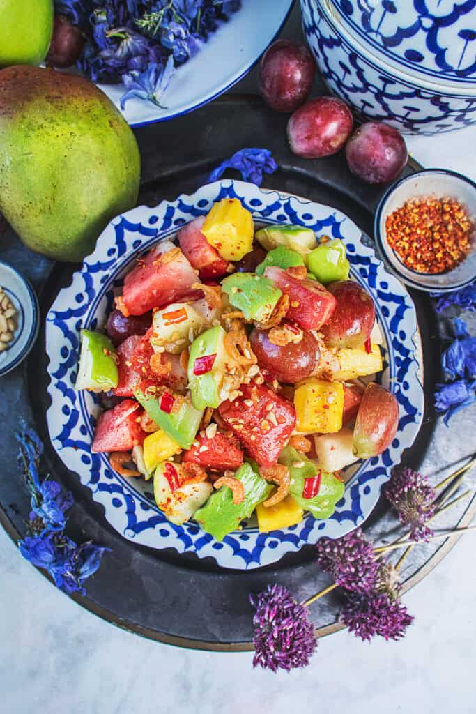 colorful thai fruit salad som tum fruit with mango watermelon grapes and chili.