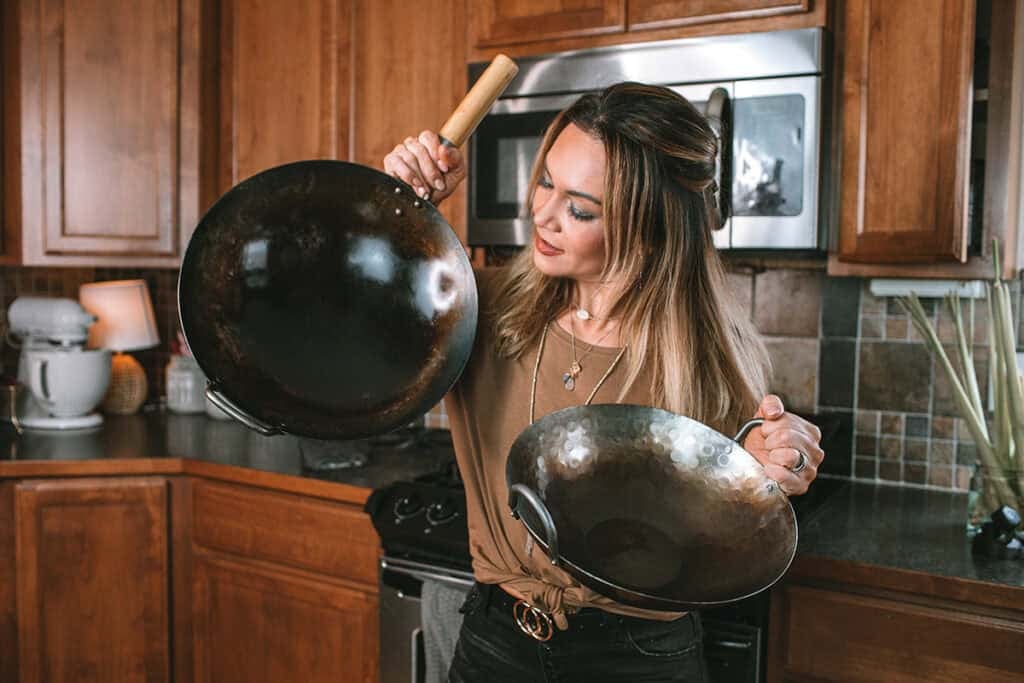Comparing a new carbon steel wok and a well-seasoned wok with years of use.