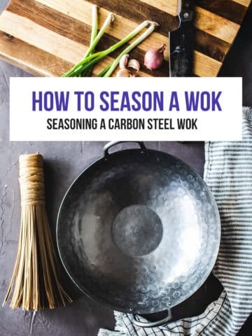 Carbon steel wok ready for seasoning with kitchen tools and ingredients.