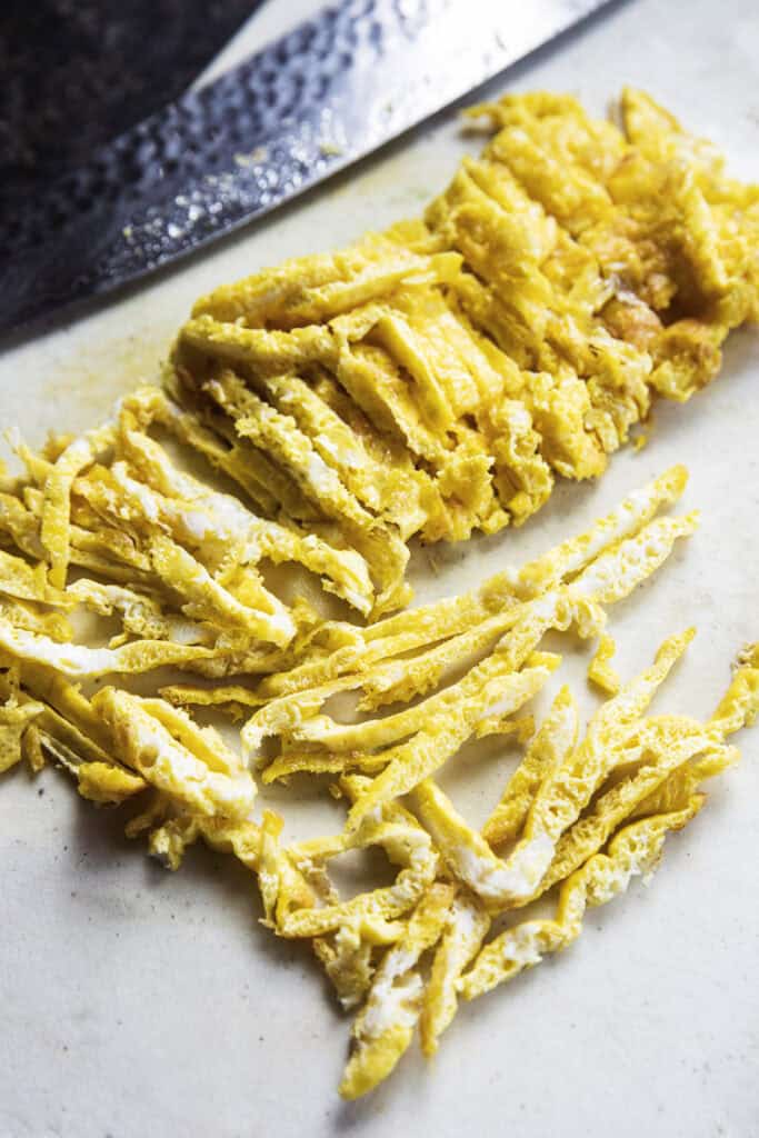 Thinly sliced egg ribbons for Thai fresh spring roll filling.