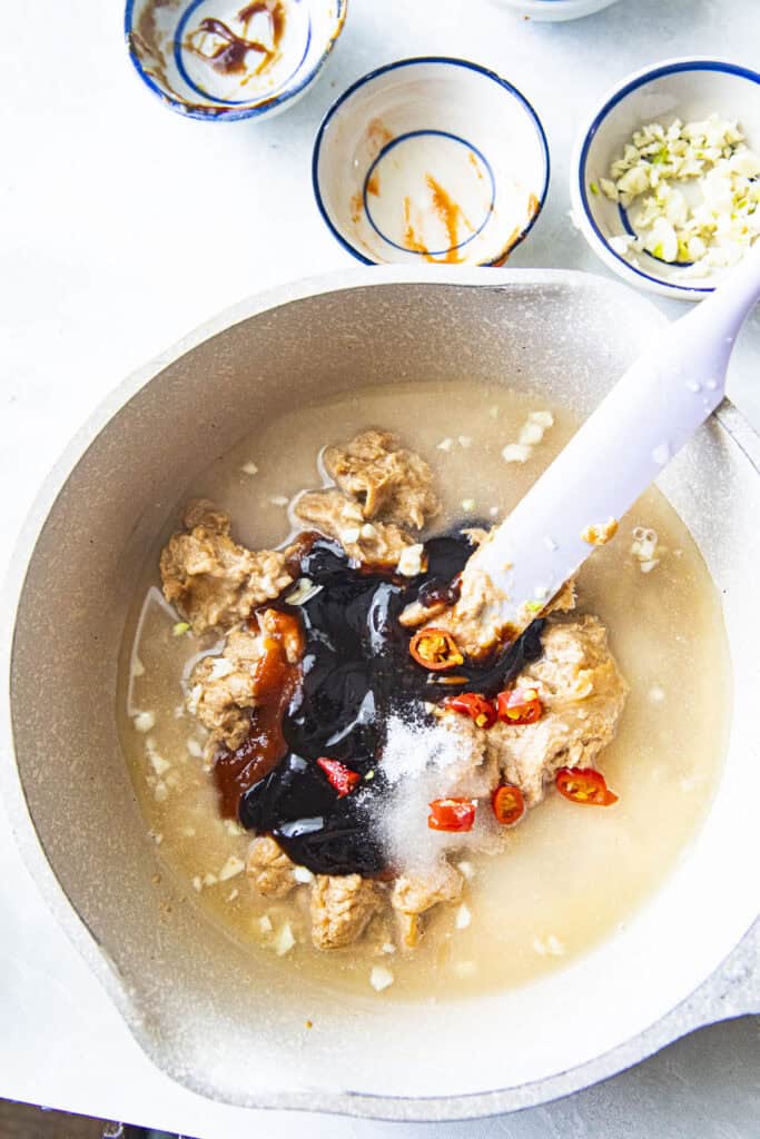 Spicy Hoisin Peanut sauce in a pot with spatula.