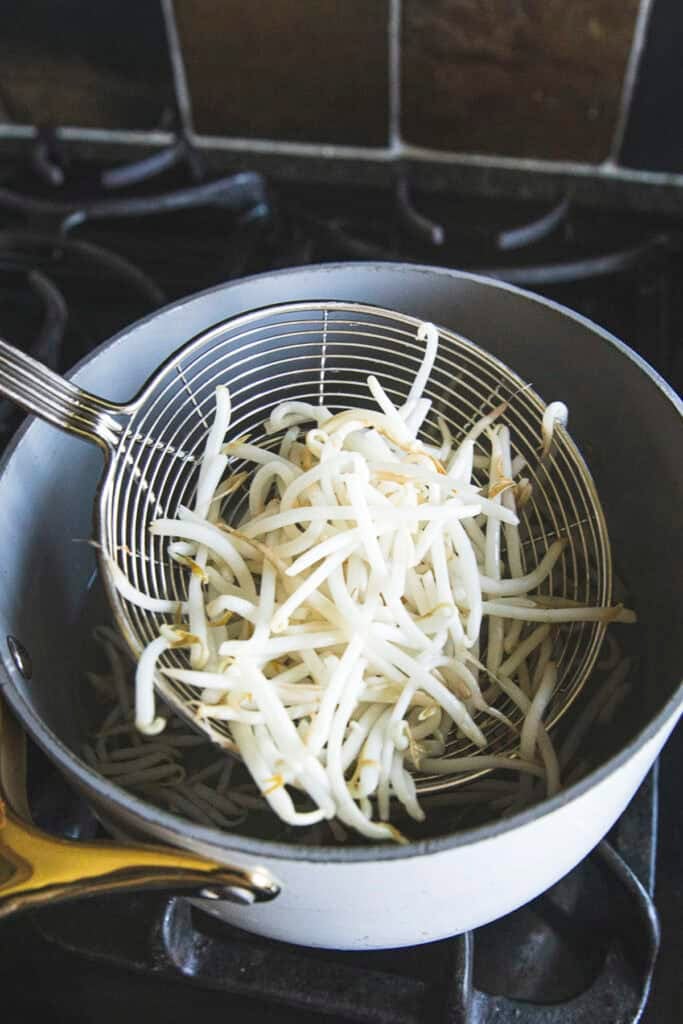 Blanching bean sprouts for Poh Pia Sod Thai fresh spring rolls.