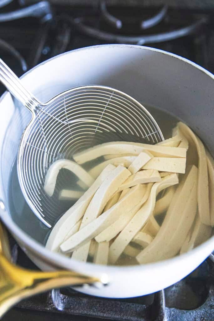 Blanching firm tofu for Poh Pia Sod Thai fresh spring rolls.