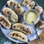 Grilled Nam Wa bananas with caramelized grill marks and caramelized coconut sauce.