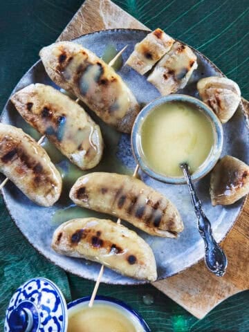 Grilled Nam Wa bananas with caramelized grill marks and caramelized coconut sauce.