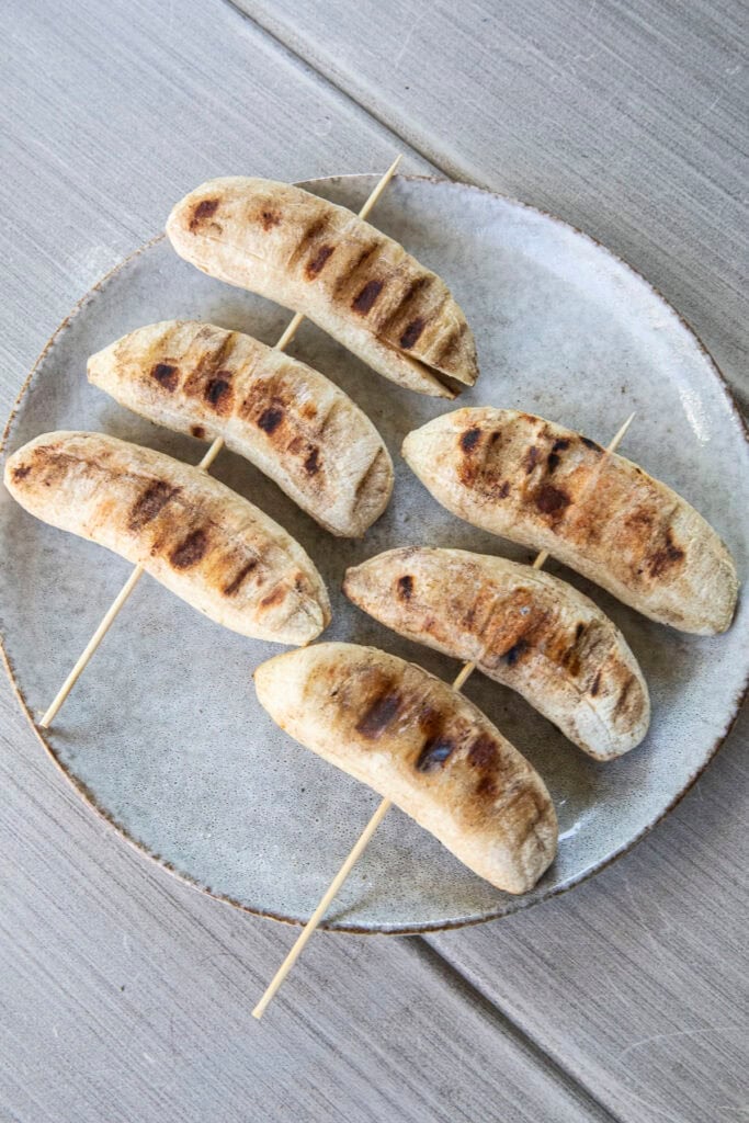 Grilled Nam Wa bananas with caramelized grill marks.