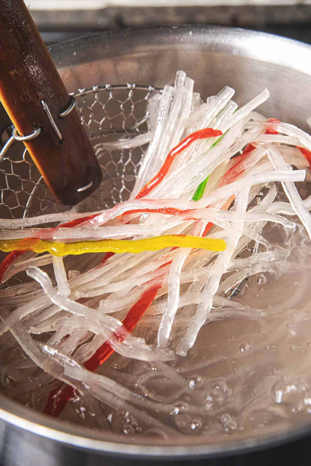 Colorful tapioca noodles cooking in boiling water for Thai shaved ice.