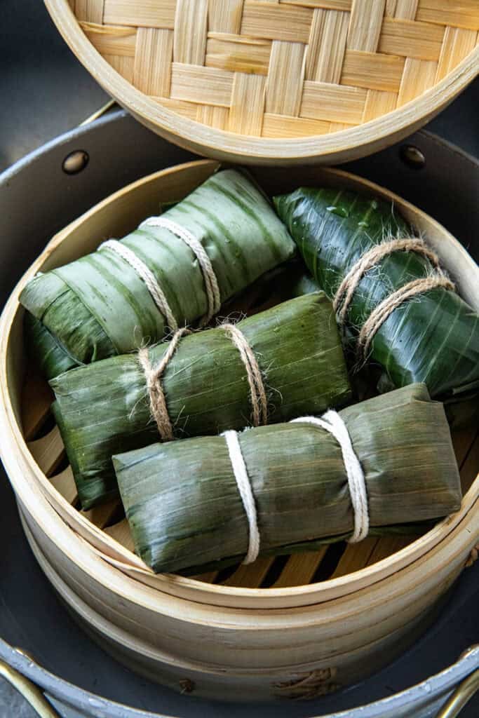 Khao Tom Mud banana leaf parcels arranged in a steamer.
