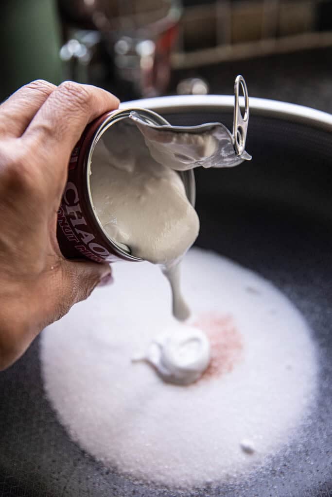 Coconut milk added to sugar and salt for Khao Tom Mud.