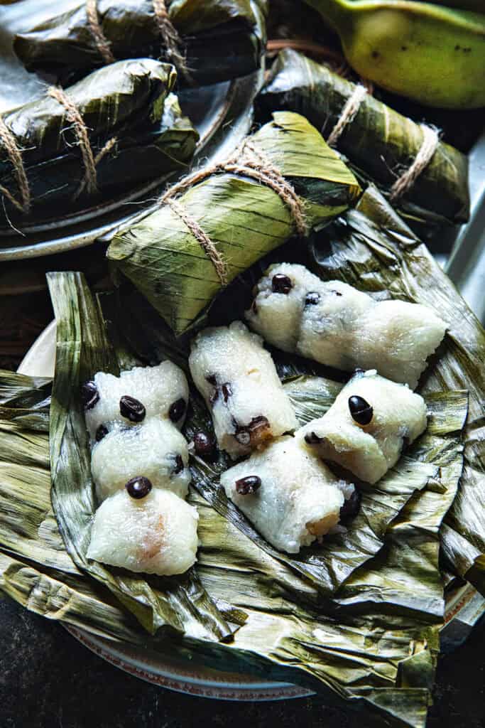 Steamed Khao Tom Mud opened to show banana sticky rice and black beans