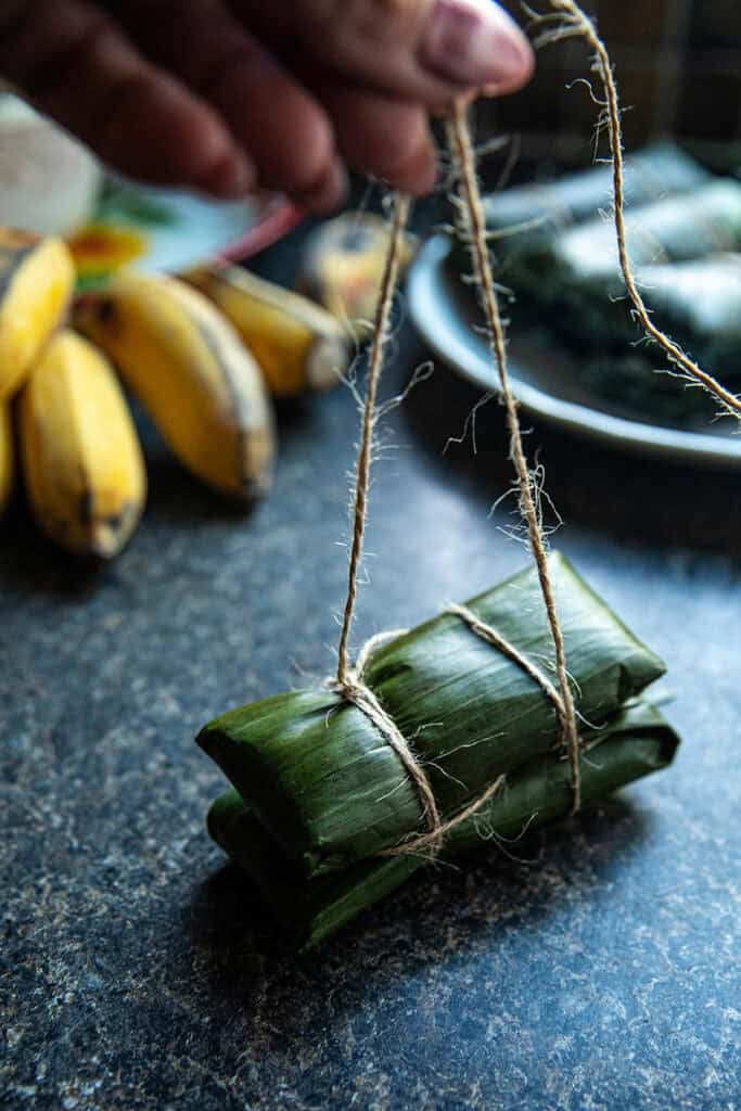Homemade Khao Tom Mud wrapped in banana leaves and tied with twine.