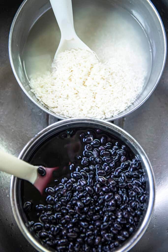 Thai sticky rice and black beans soaking for Khao Tom Mud.
